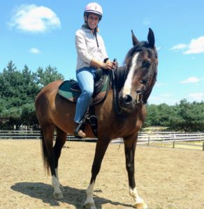 Jackie, shown in western gear, is a favorite teacher for students.